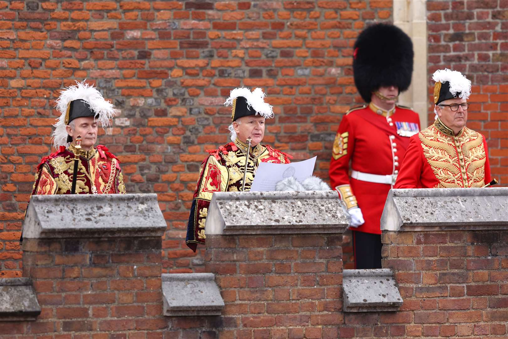 Garter Principal King of Arms, David Vines White, centre, reads the proclamation from the Friary Court balcony of St James’s Palace (Richard Heathcote/PA)