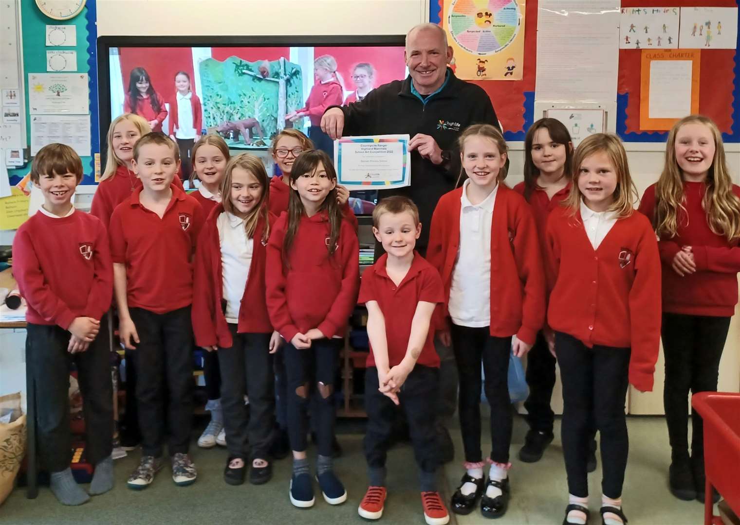 Pupils at Balnain Primary School receive their winning certificate from High Life Highland ranger John Orr. Picture: Andy Summers/HLH