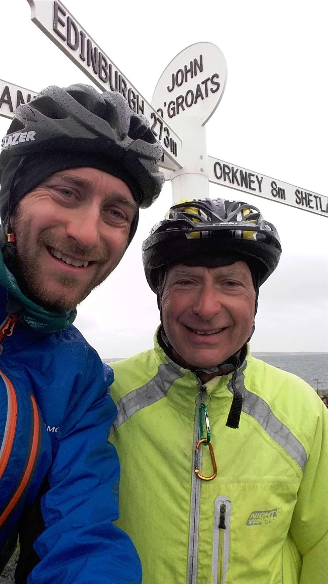 End of the road: John and his dad at the milepost at John O'Groats.
