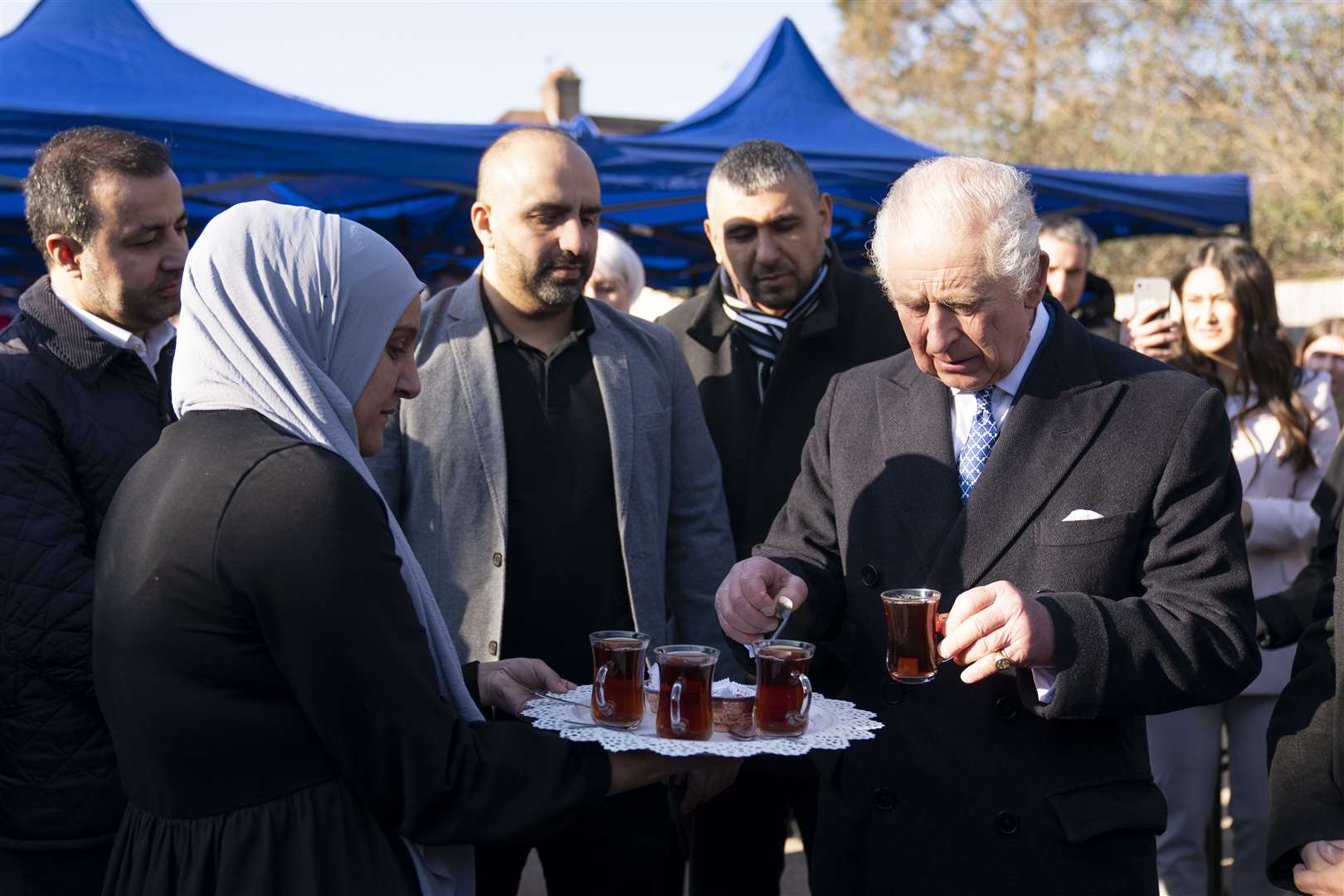 The monarch enjoys tea on a visit to West London Turkish Volunteers in Hounslow (Kirsty O’Connor/PA)