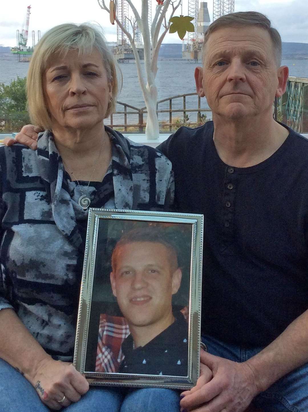 Wendy and Patrick Mullery with a photo of their son James who took his own life aged just 28.