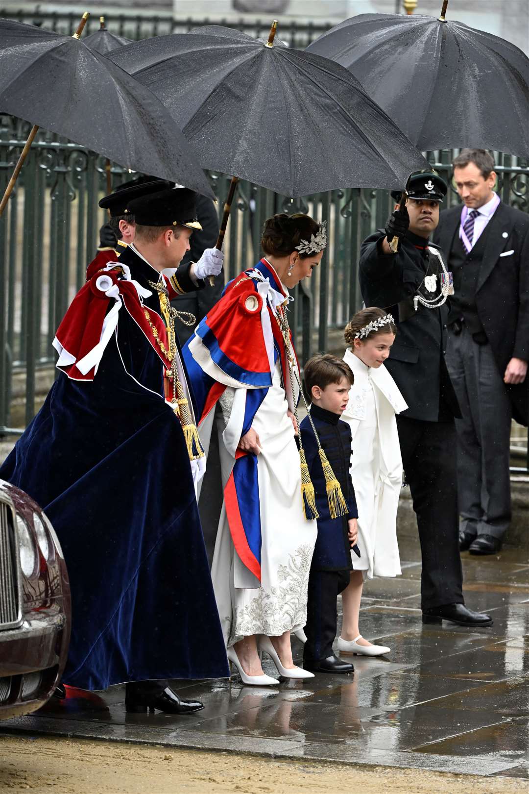 The family arrived in the rain outside Westminster Abbey (Toby Melville/PA)