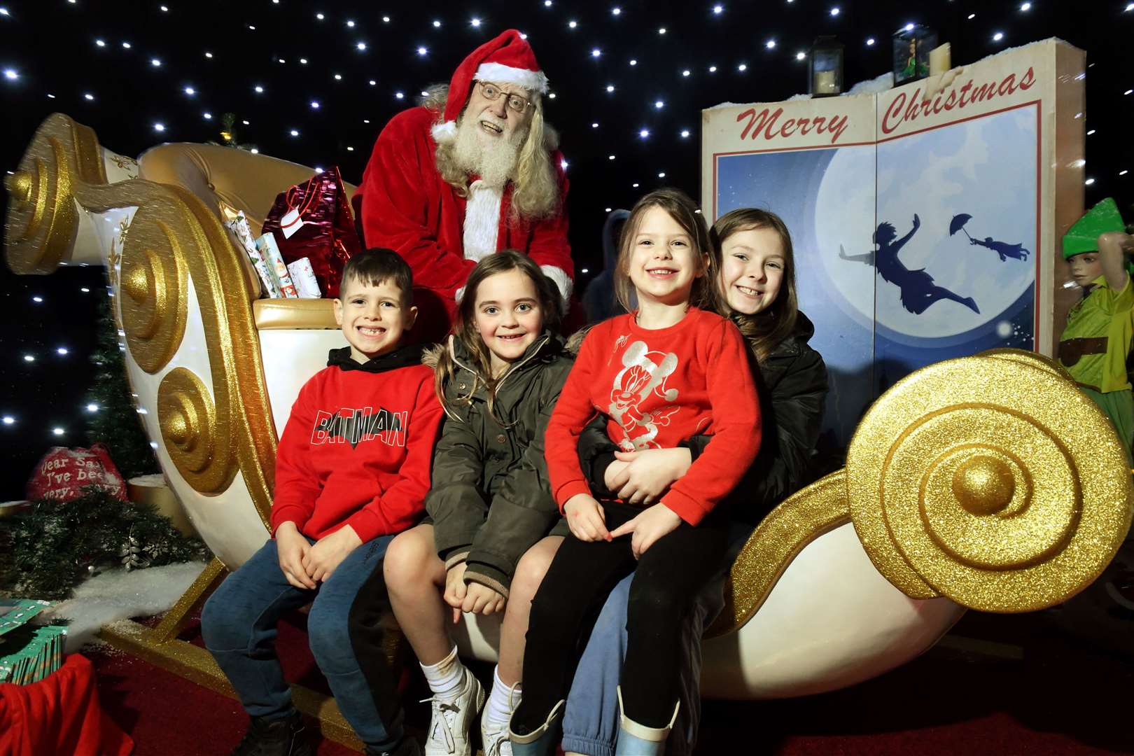 Stephen Murray, Breigha Andrew, Freya Murray and Mia Sutherland get a photo with Santa. Picture: James Mackenzie