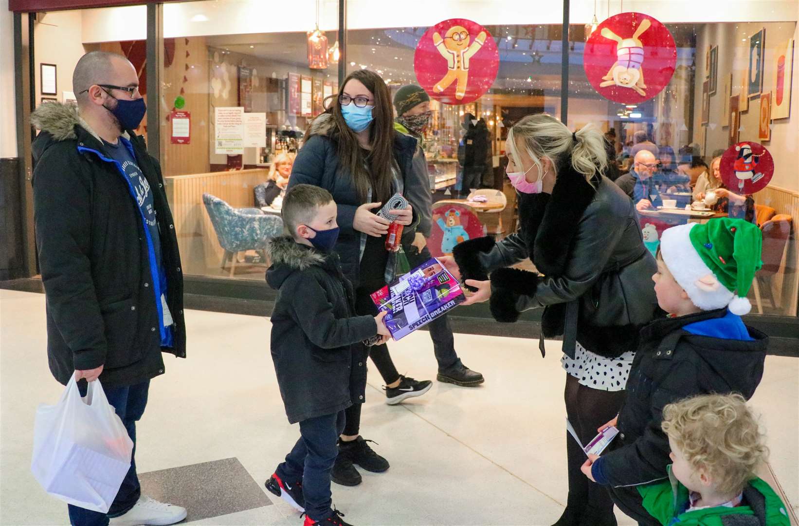 Young shoppers at the Eastgate Shopping Centre receive surprise gifts from secret Santas.