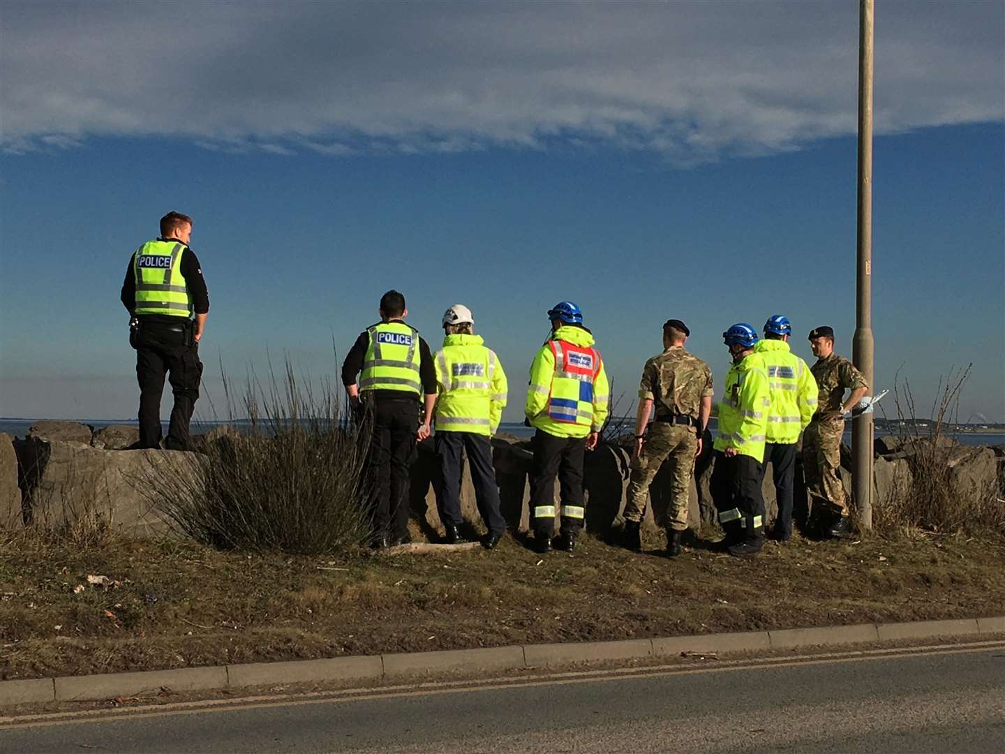 Members of the Royal Navy bomb disposal team looking at the object while it was still submersed near Kessock Bridge in Inverness.