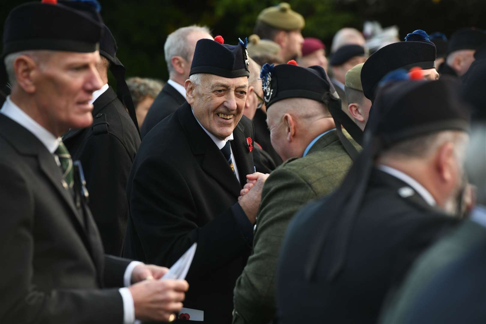 Veterans have a catch-up as the parade reaches the war memorial.