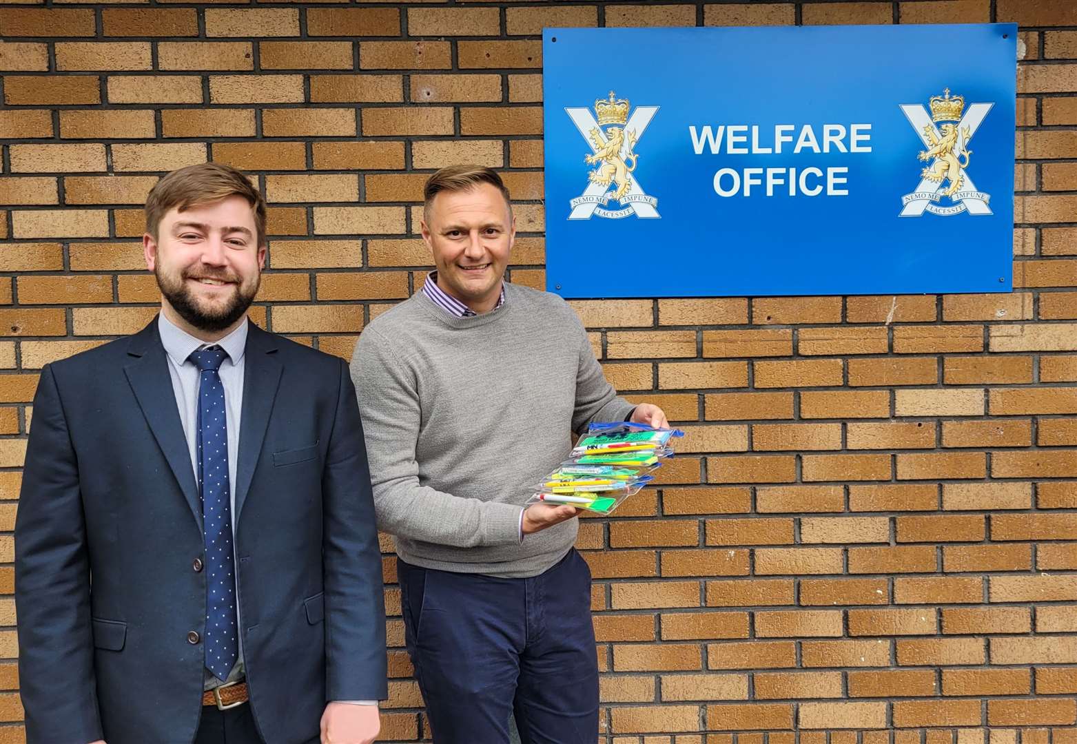 Munro and Noble solicitor Steven Grant hands over the pencil kits to Captain Richard Grisdale at the Army Welfare Office in Wimberley Way, Inverness.