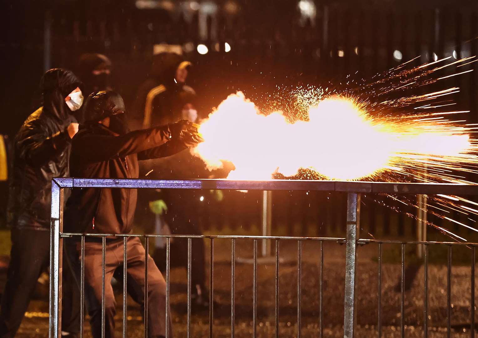 Youths discharge fireworks at the PSNI on the Springfield Road (Liam McBurney/PA)