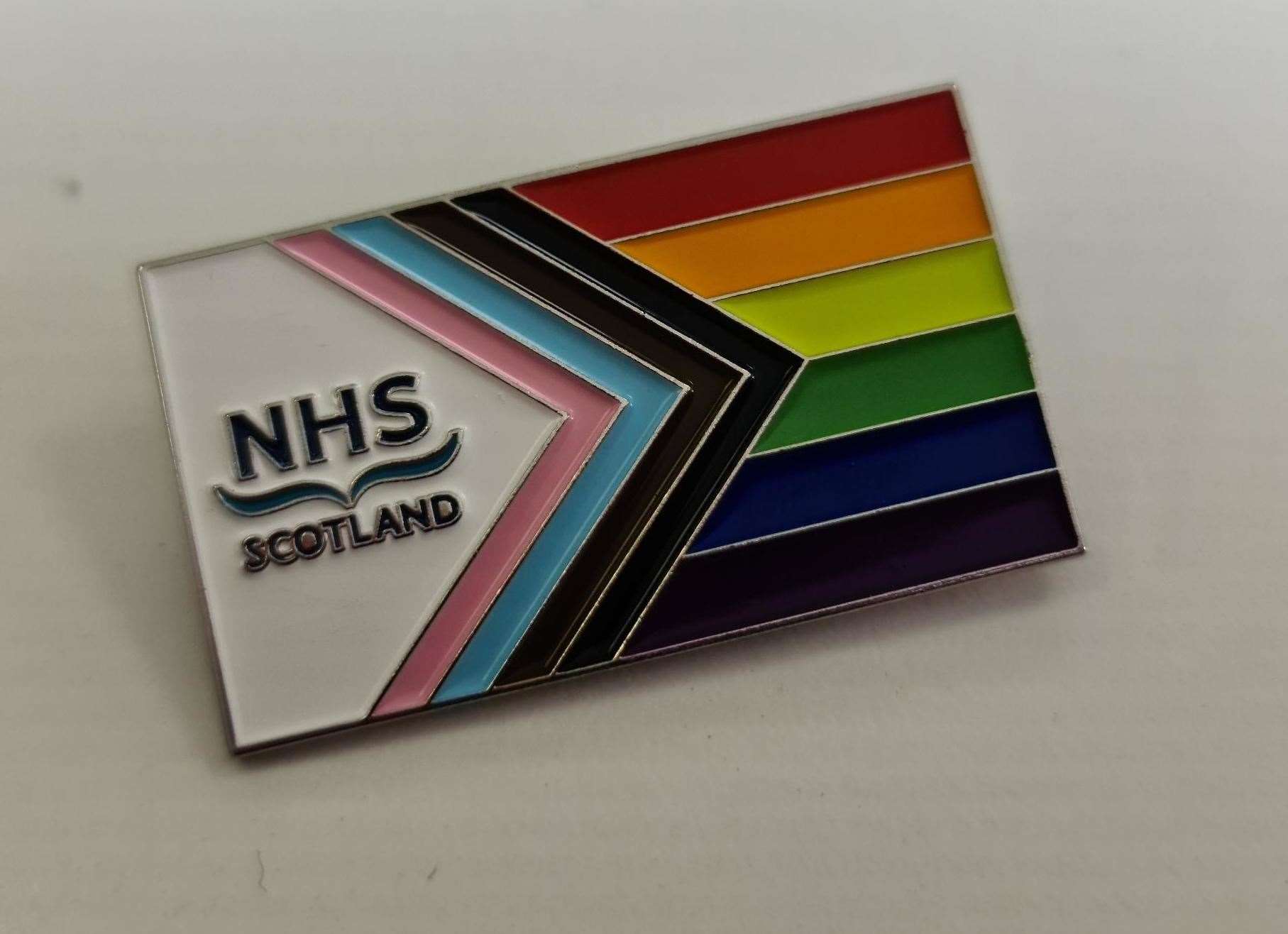 NHS Pride badge.