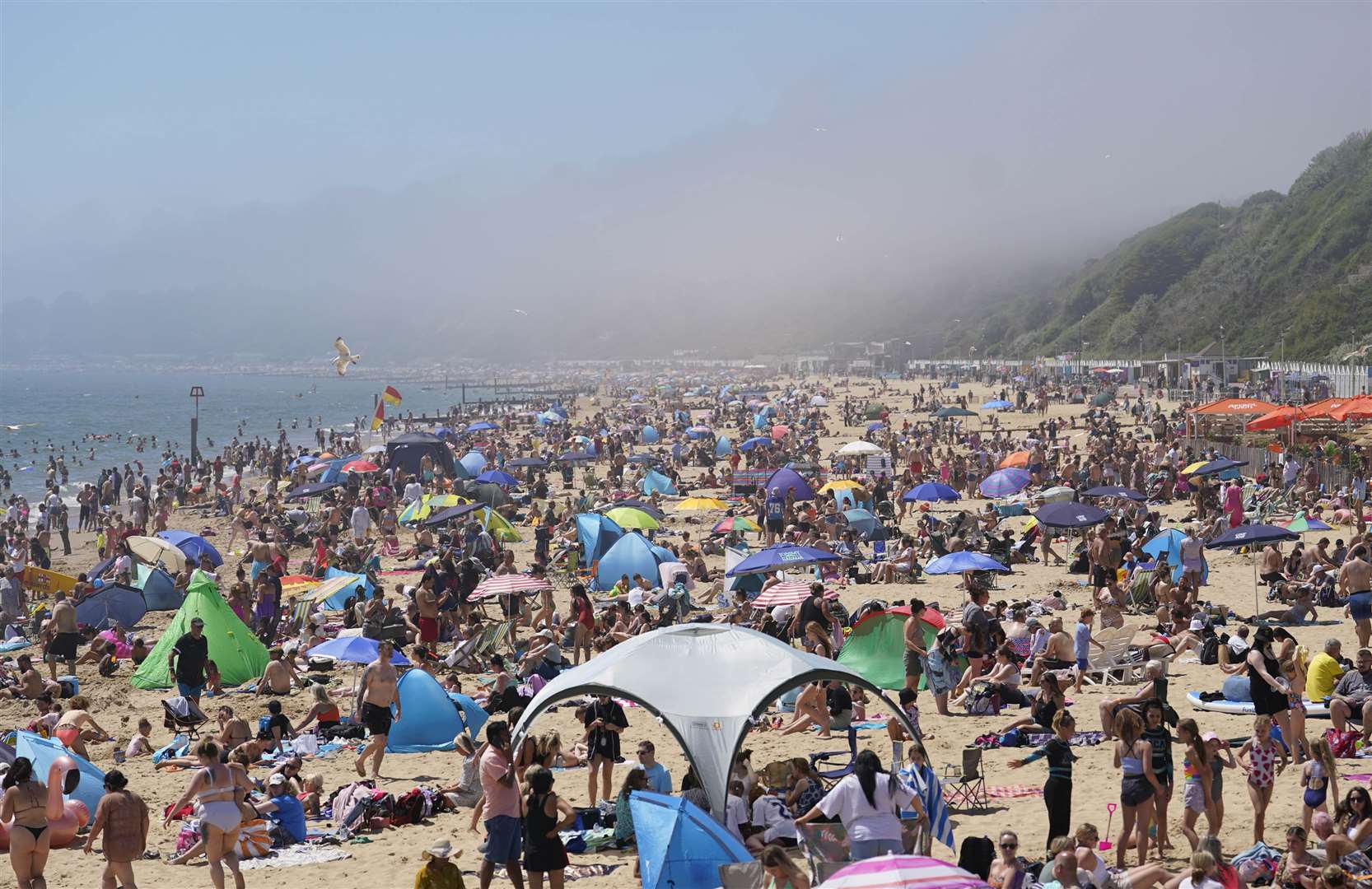 In Dorset, the sands were packed in Bournemouth, as thousands ventured to the beach with umbrellas and shelters (Andrew Matthews/PA)