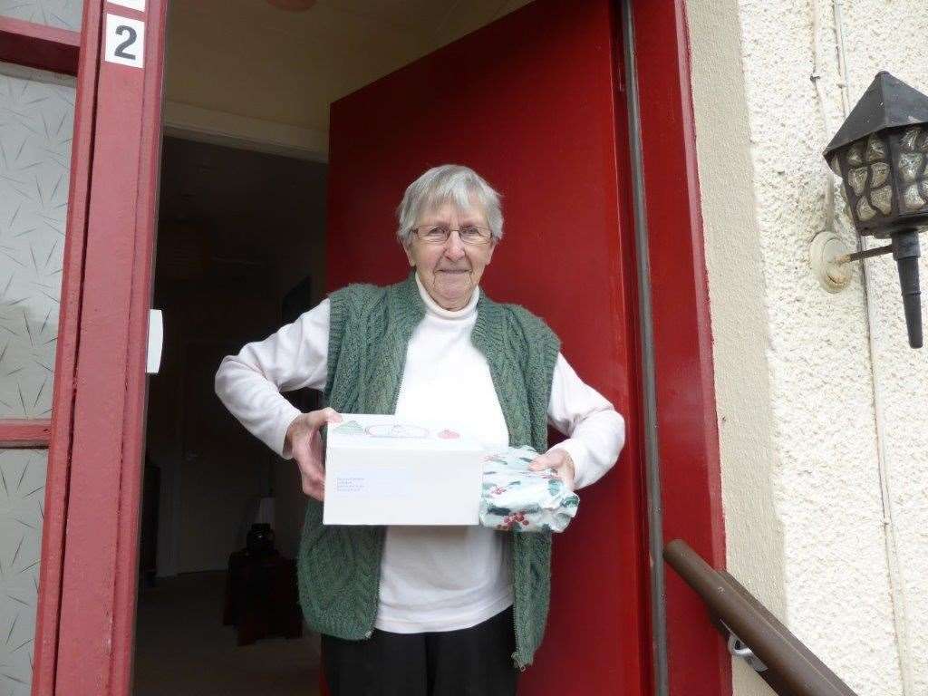 Dorothy Cameron receives her cake and sandwich selection.