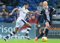 Dundee's new signing Faissal El Bakhtaoui takes on Ross County's Andrew Davies.