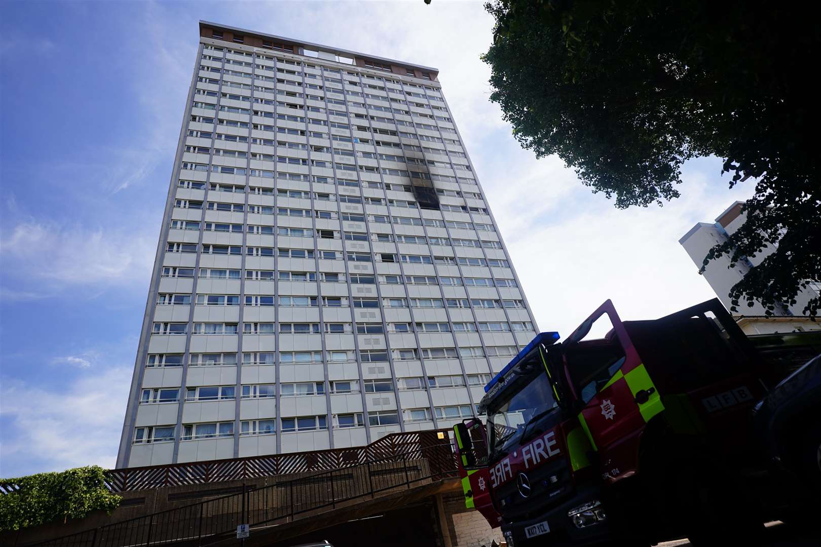 Fire crews in front of the tower block at Stebbing House in Shepherds Bush, London (PA)