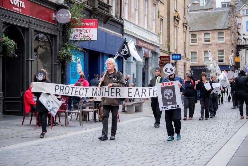 Marchers carry environmental warnings at last year’s Earth Day event in Inverness.