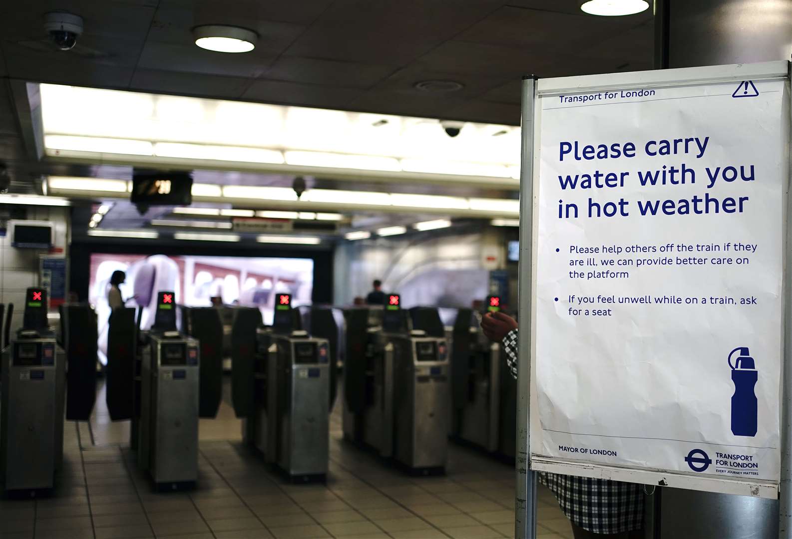 A sign advised people to carry water at Bank Tube station in London (Aaron Chown/PA)