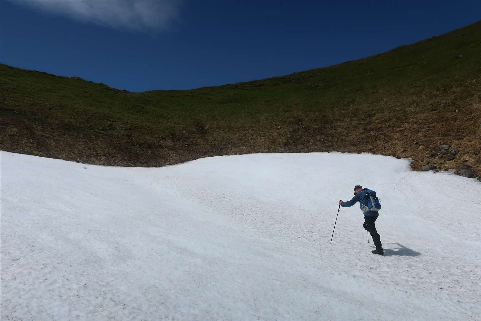 Peter crossing the late snow patch at Uinneag Coire an Lochain.