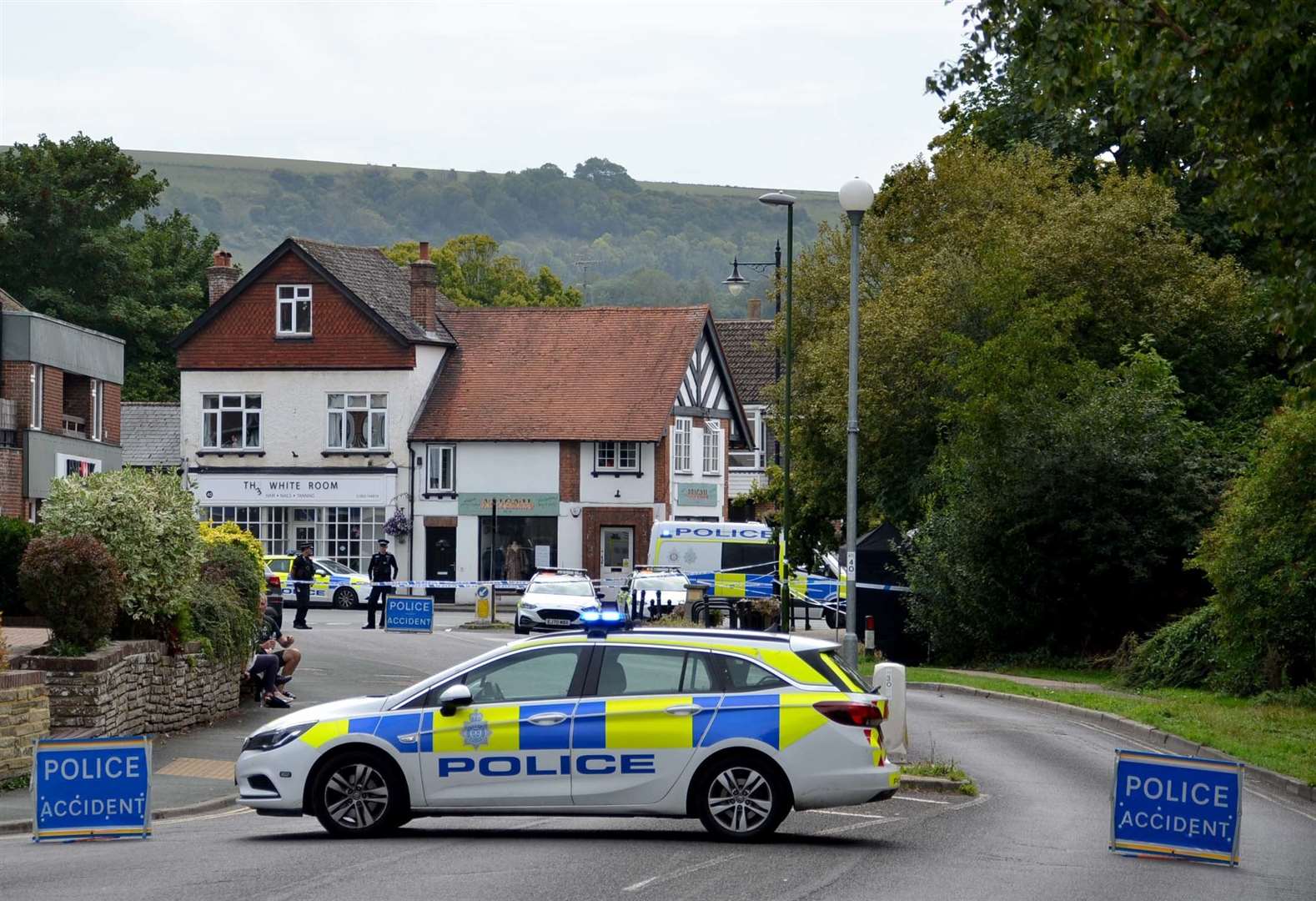 Police vehicles near the scene (Clive Gee/PA)