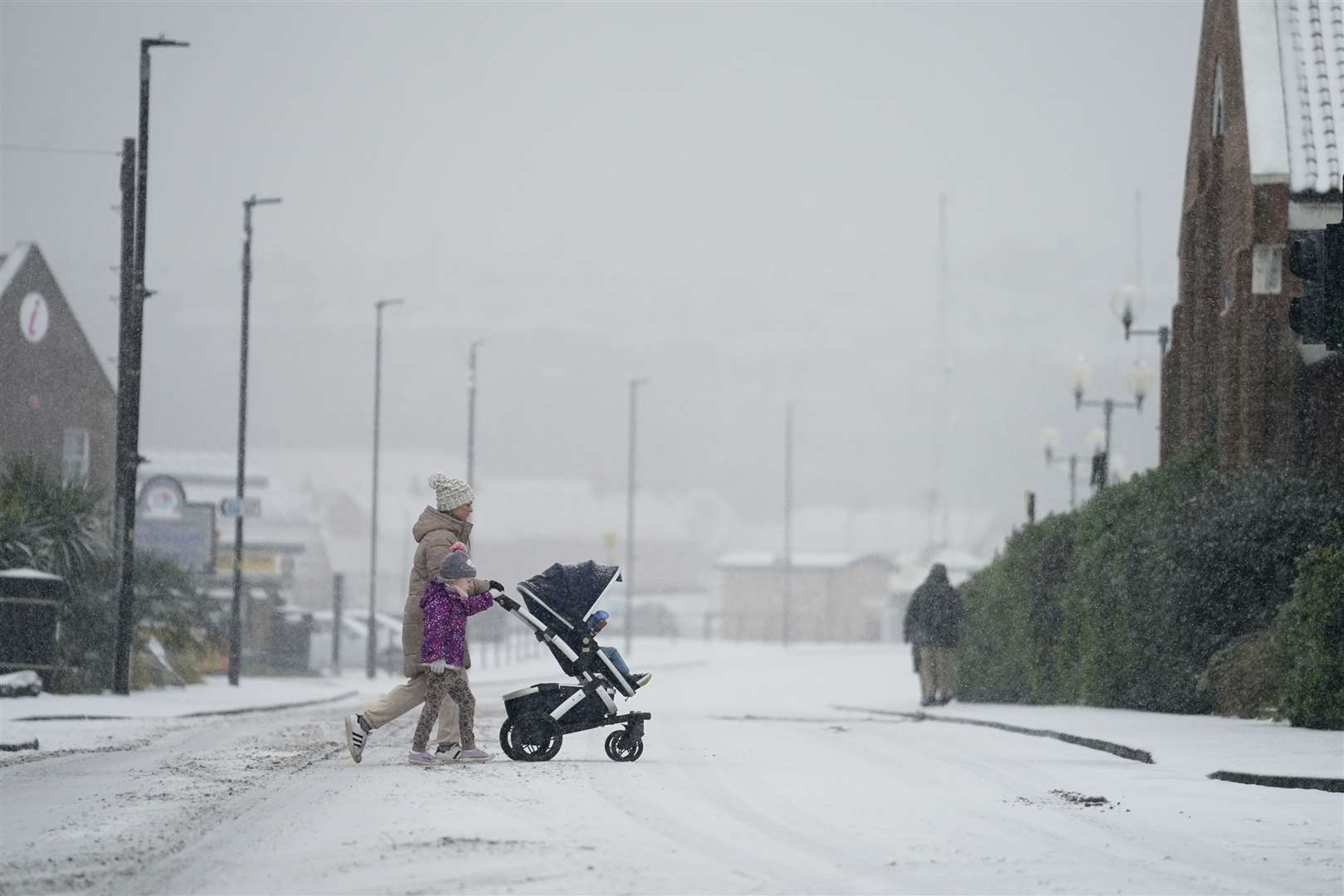 People make their way through snow in Whitby (Danny Lawson/PA