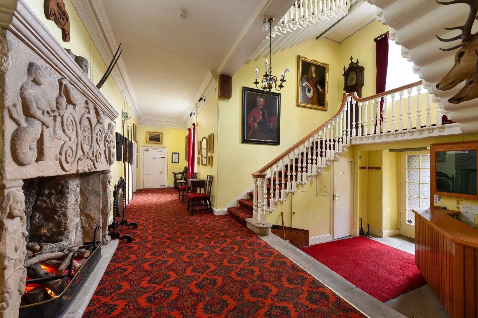 The hall with its imposing stone fireplace greets visitors to Kilravock Castle.