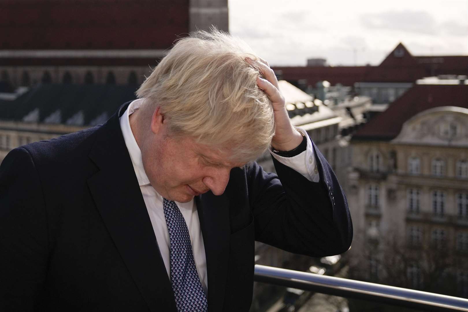 Prime Minister Boris Johnson rubbing his hair to get ready for a interview during the Munich Security Conference in Germany (Matt Dunham/PA)