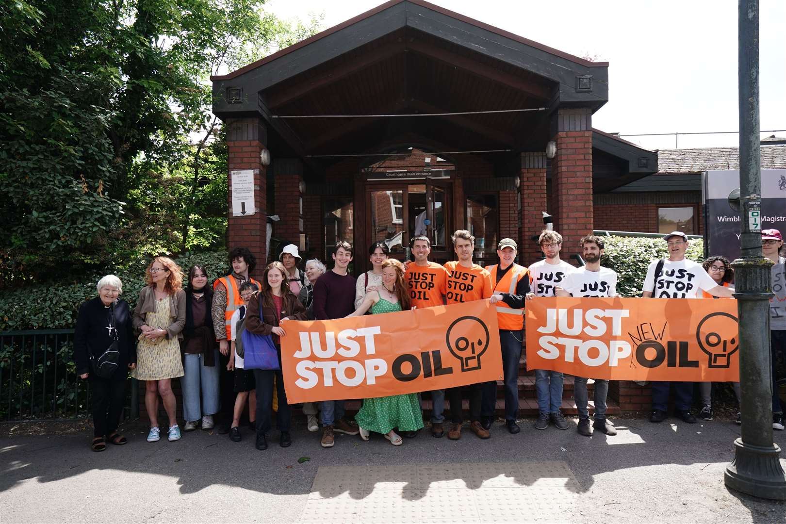 Two Just Stop Oil protesters Samuel Johnson, and Patrick Hart, centre right, with supporters at Wimbledon Magistrates’ Court (Jordan Pettitt/PA)