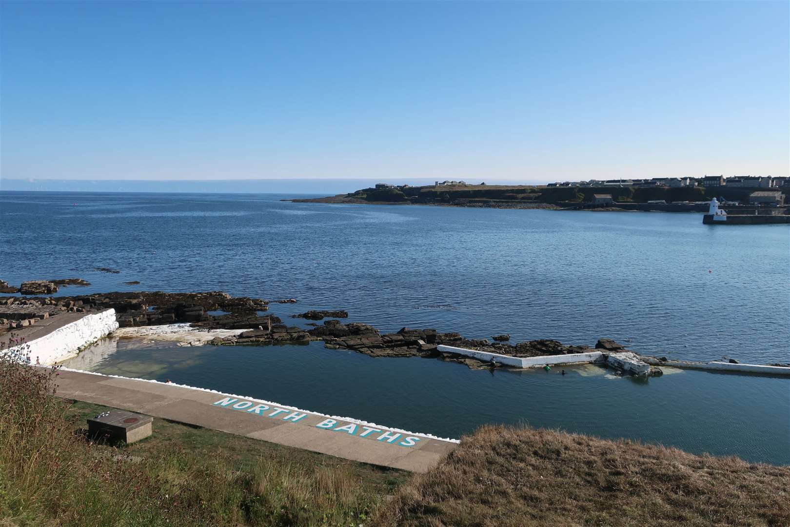 Looking over the North Baths and Wick Bay towards the South Head.