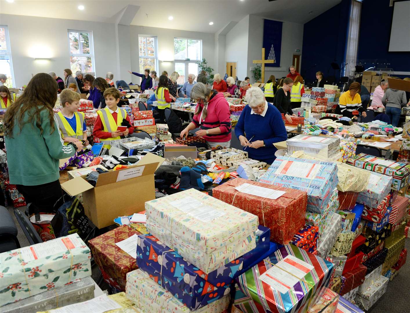 Volunteers putting together boxes of goods for the needy is a sign of practical love at Christmas. Picture: Gary Anthony.