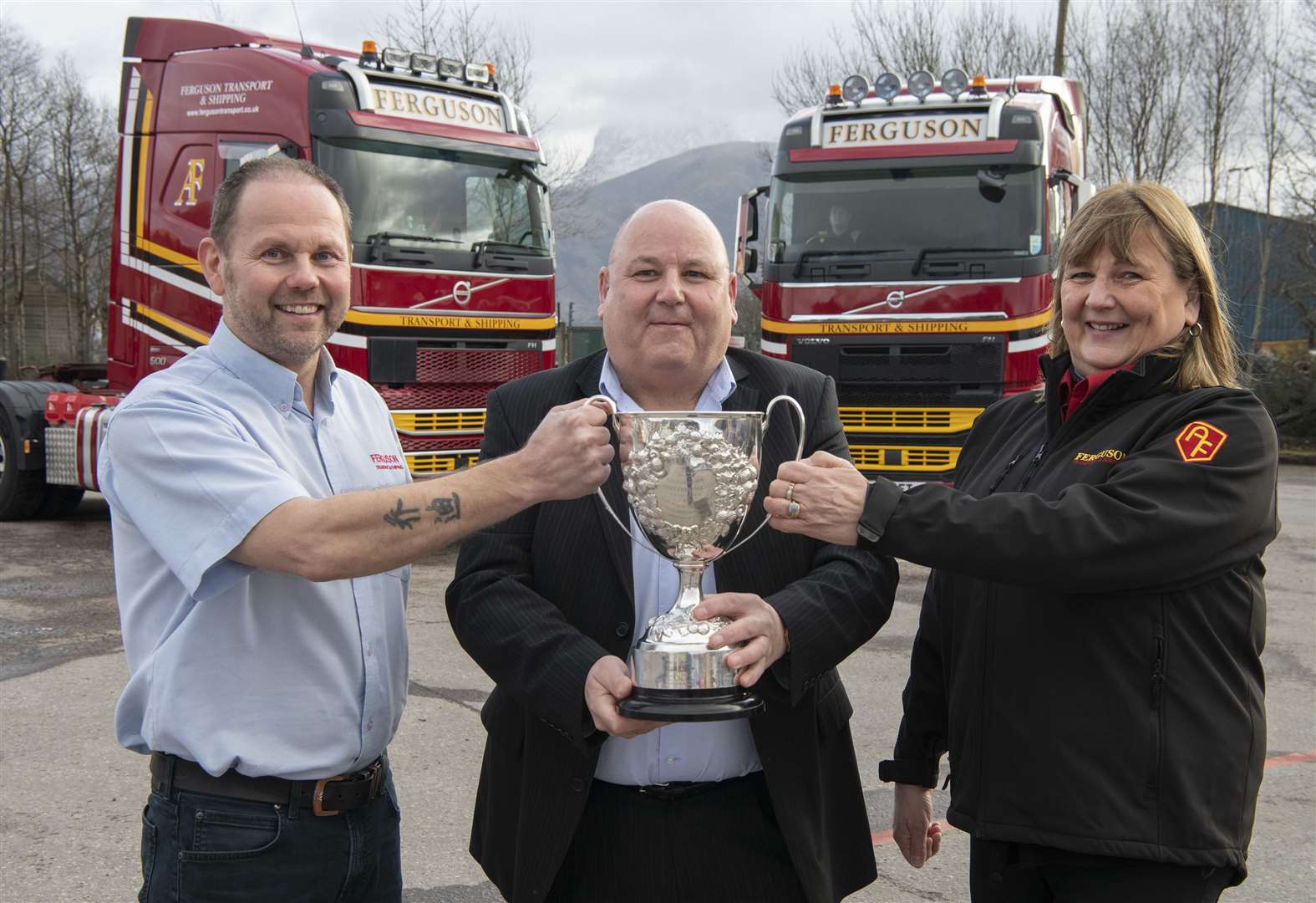 Alasdair Ferguson (centre) of Balliemore Cup sponsors, Ferguson, Transport and Shipping with directors Jack Ferguson and Lesley Innes, who made the draw. Photograph: Iain Ferguson, The Write Image