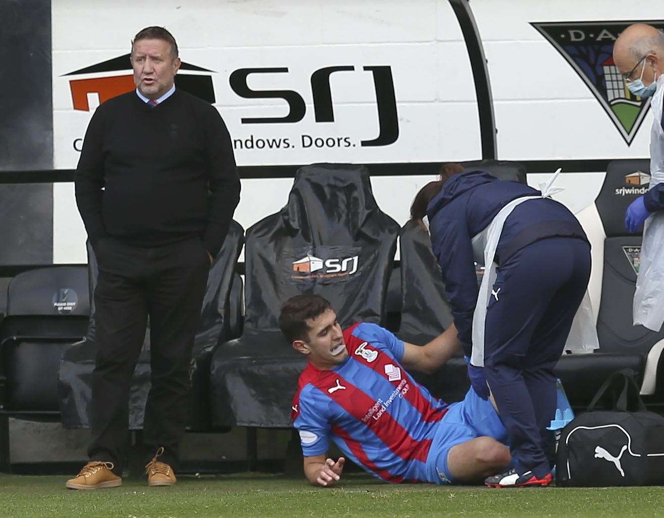 Picture - Ken Macpherson, Inverness. Dunfermline(3) v Inverness CT(1). 17.10.20. ICT’s Nickolay Todorov is treated for his injury as manager John Robertson contemplates playing the game without his only striker.