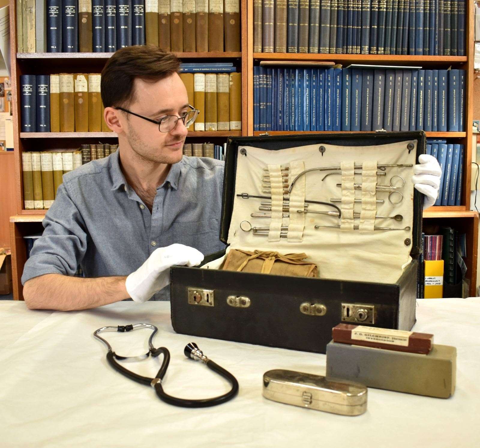 Museum assistant Joe Setch with a medical bag owned by Dr Auchterlonie of Invergordon.