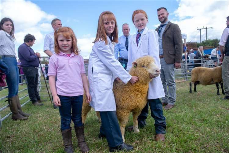 Chloe, Lucy and Sophie Anderson showing Orange, their Dorset sheep. Picture: Callum Mackay