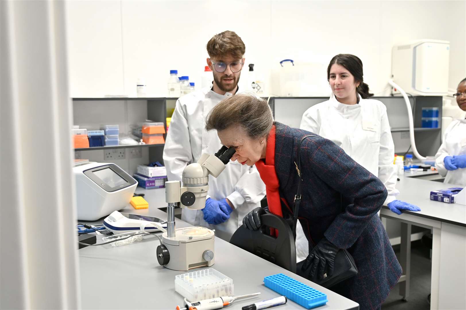 Princess Anne takes a look down a microscope during a tour of the new Rural and Veterinary Innovation Centre.