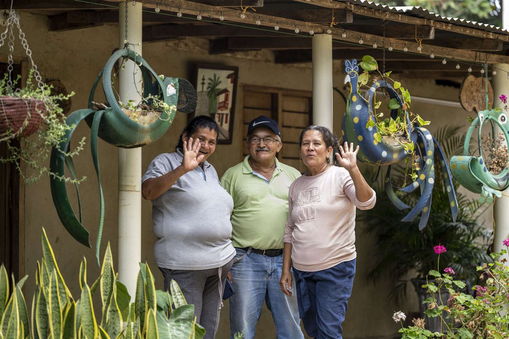 Jaime Garcia Florez with his wife Marlena Lopez (right) and another family member outside their home in the Siberia township (Chris Terry/Fairtrade/PA)
