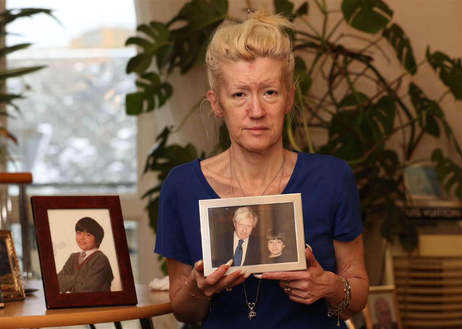 Jasna Badzak holding a photograph of her son Sven, taken with Boris Johnson during his London mayoral campaign in 2008 (Jonathan Brady/PA)
