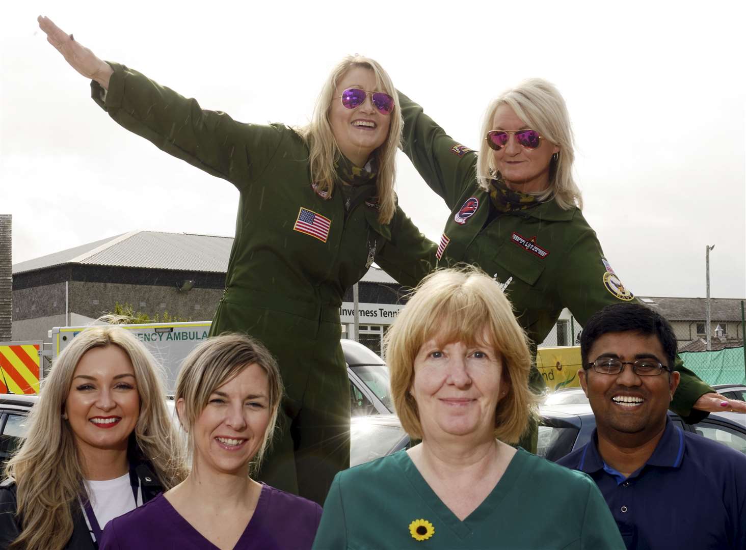 Morag McGilvray and Joan Mackenzie in their Top Gun outfits with staff from the Highland Hospice..Picture: James Mackenzie
