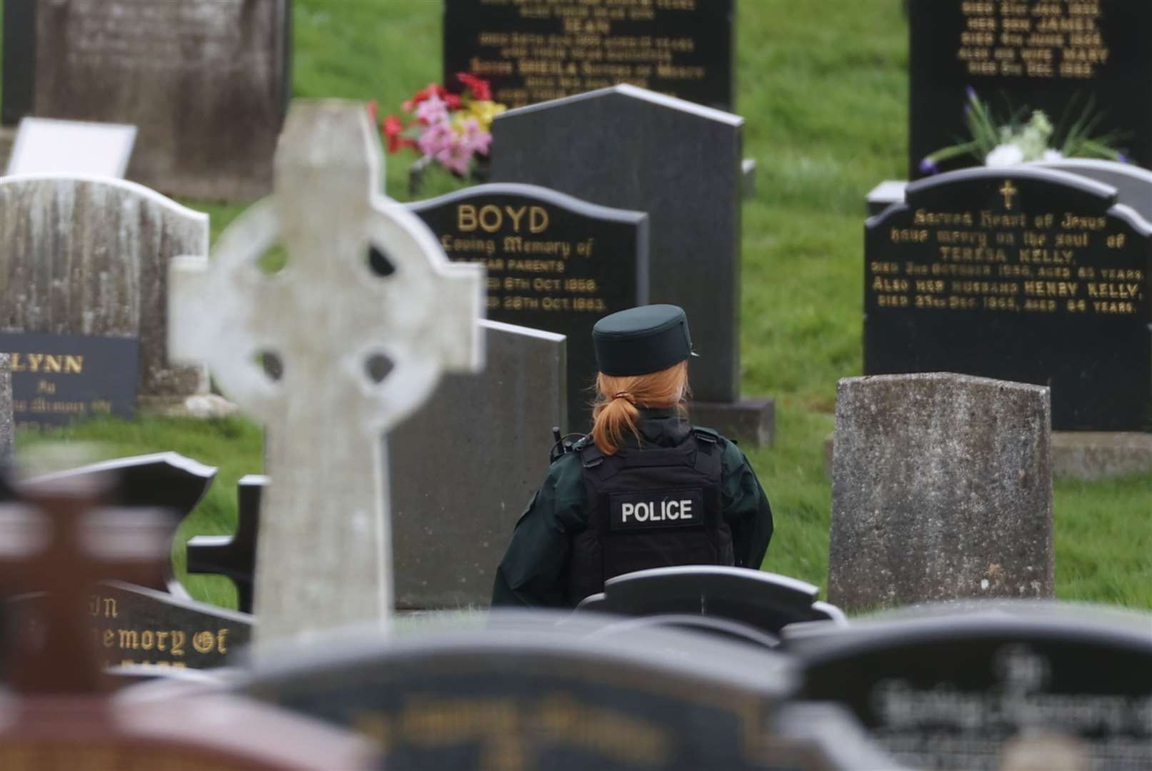 A PSNI officer inside the cemetery on Tuesday (Liam McBurney/PA)