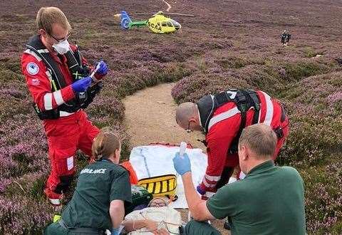 SCAA paramedics in action alongside Scottish Ambualnce Service road crew colleagues at the scene of a hillwalking accident on Benachie.