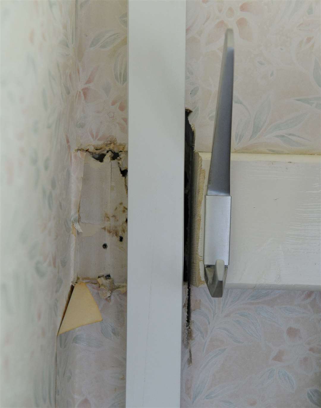 John Ballie is unhappy with damge after fitting of new heating system.Holes cut into hall wall.Picture Gary Anthony.