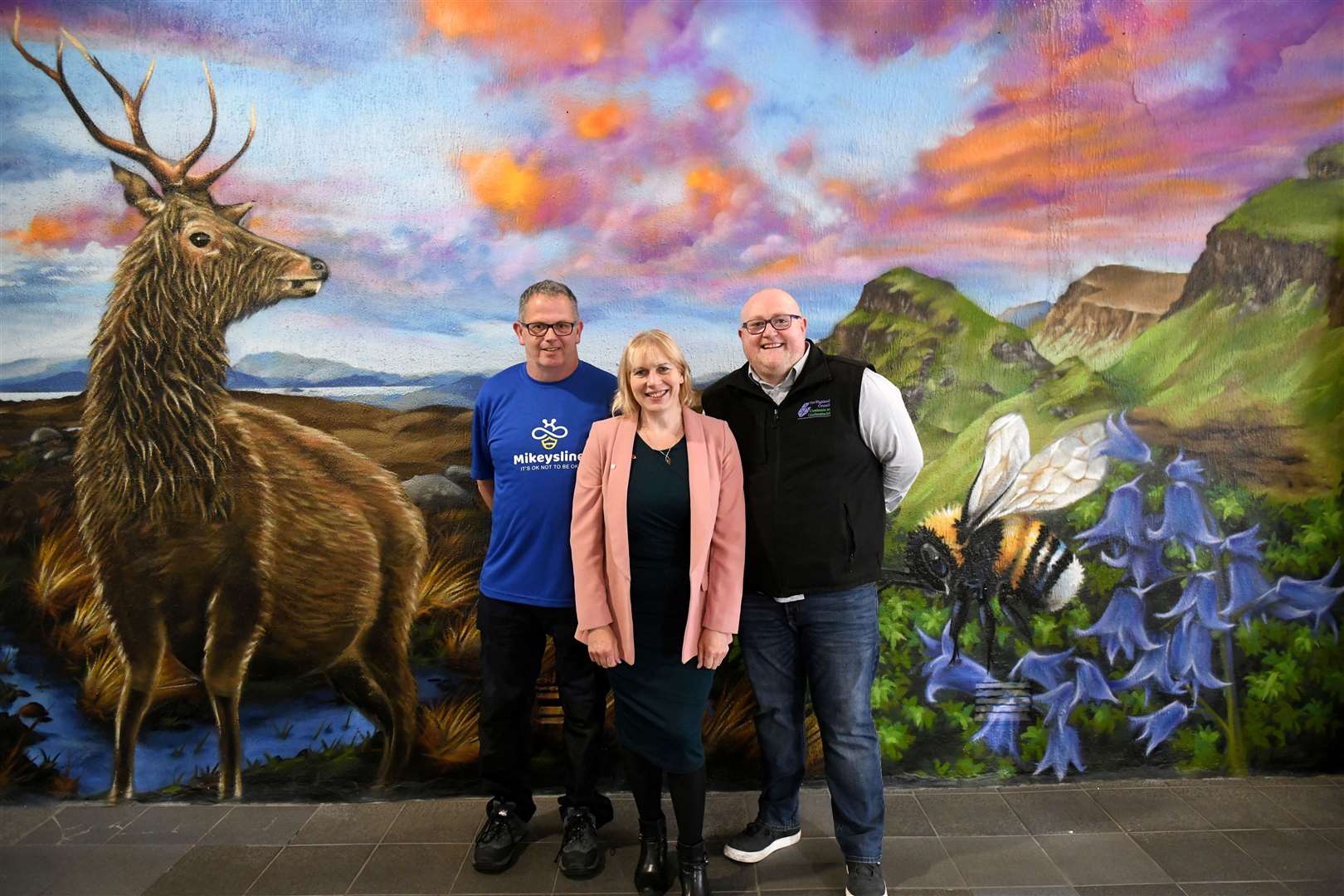Market assistant Donald Hunter, Emily Stokes, chief executive of Mikeysline, and Cameron Macfarlane, acting manager of the Victorian Market admire the new mural. Picture: James Mackenzie.