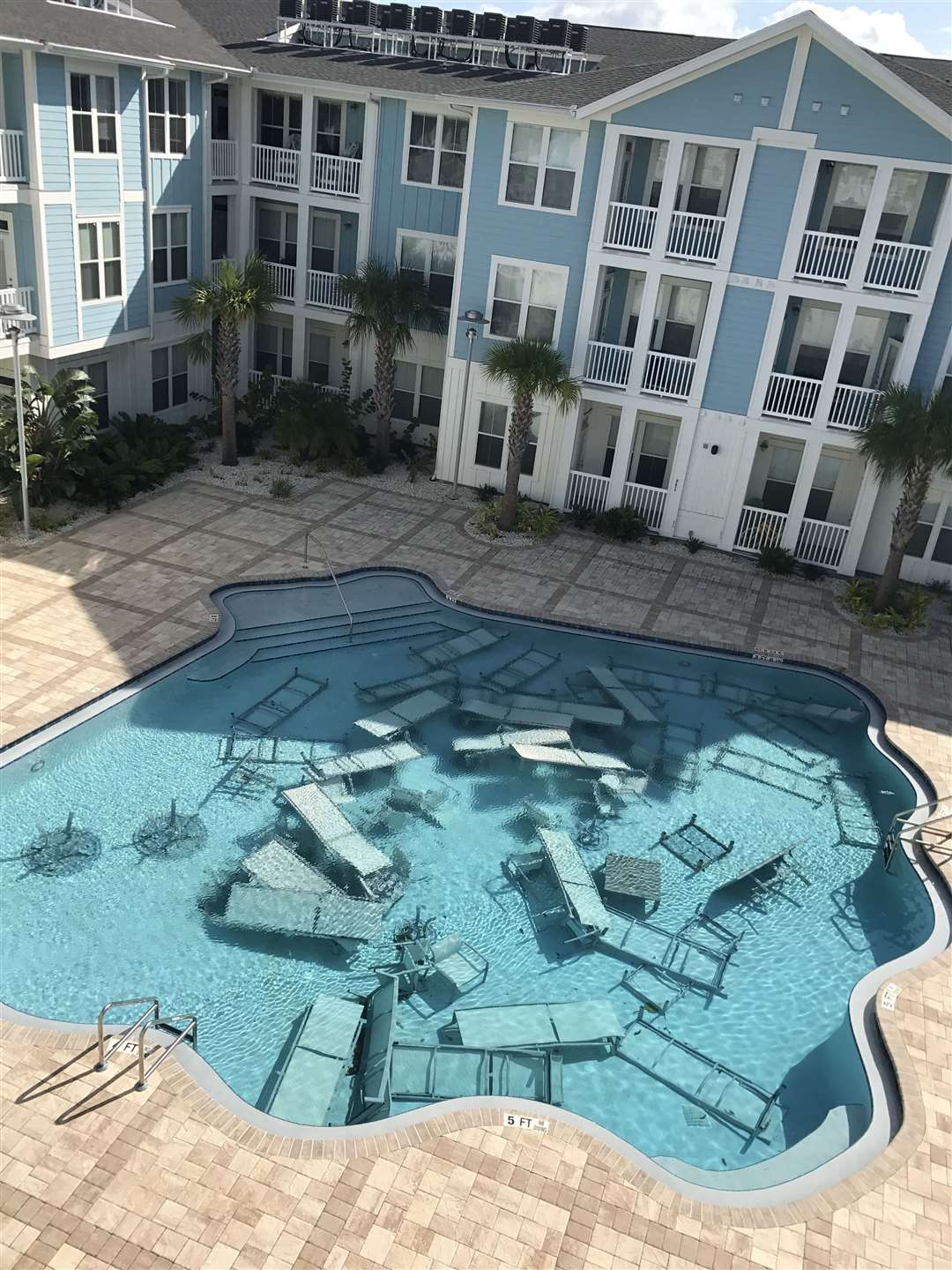 Aftermath at an apartment complex following a previous weather event in Florida.