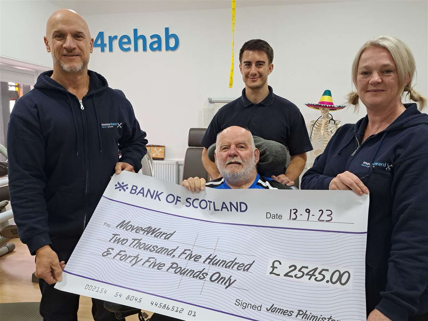 James Phimister (centre) raised £2545 for Move4Ward Physiotherapists in Elgin.