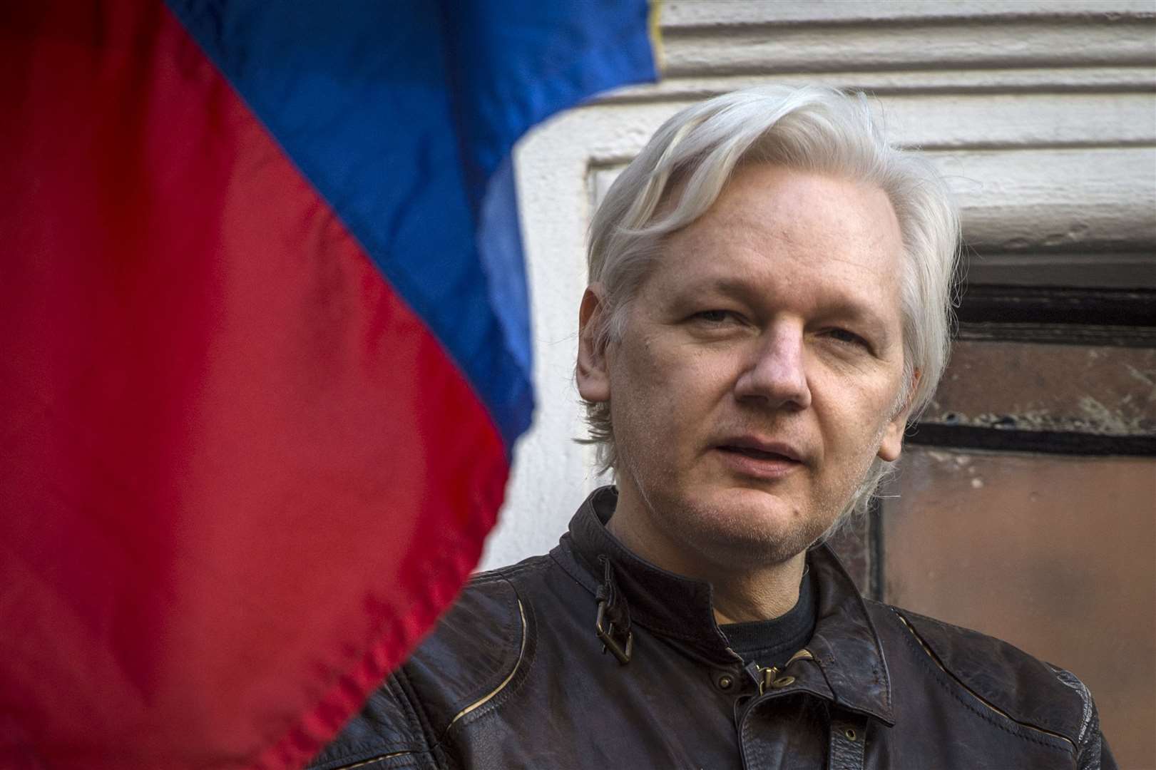 Julian Assange speaks from the balcony of the Ecuadorian embassy in 2017 (PA)