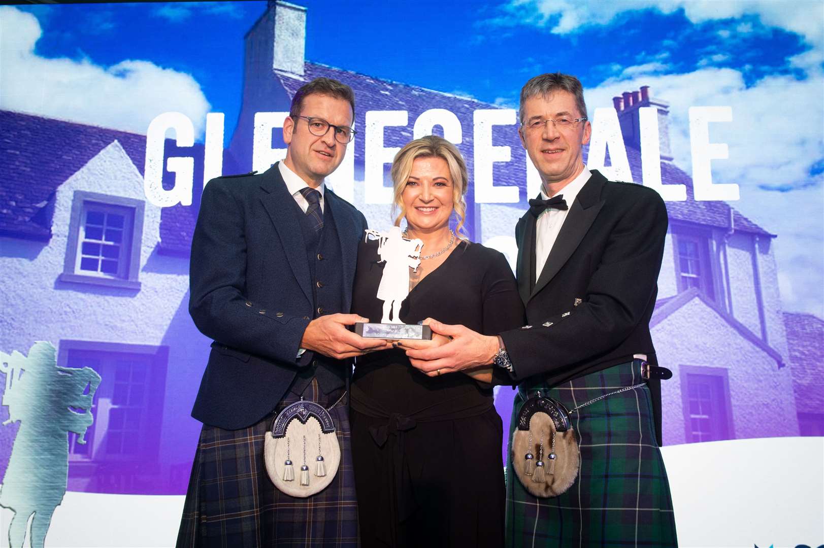 Graeme and Emma Clark of Glenegedale House on Islay accept the HITA award for most hospitable B&B/Guest House from Douglas Sharpe (right), business development manager with category sponsor Scottish Building Society. Picture: Callum Mackay.