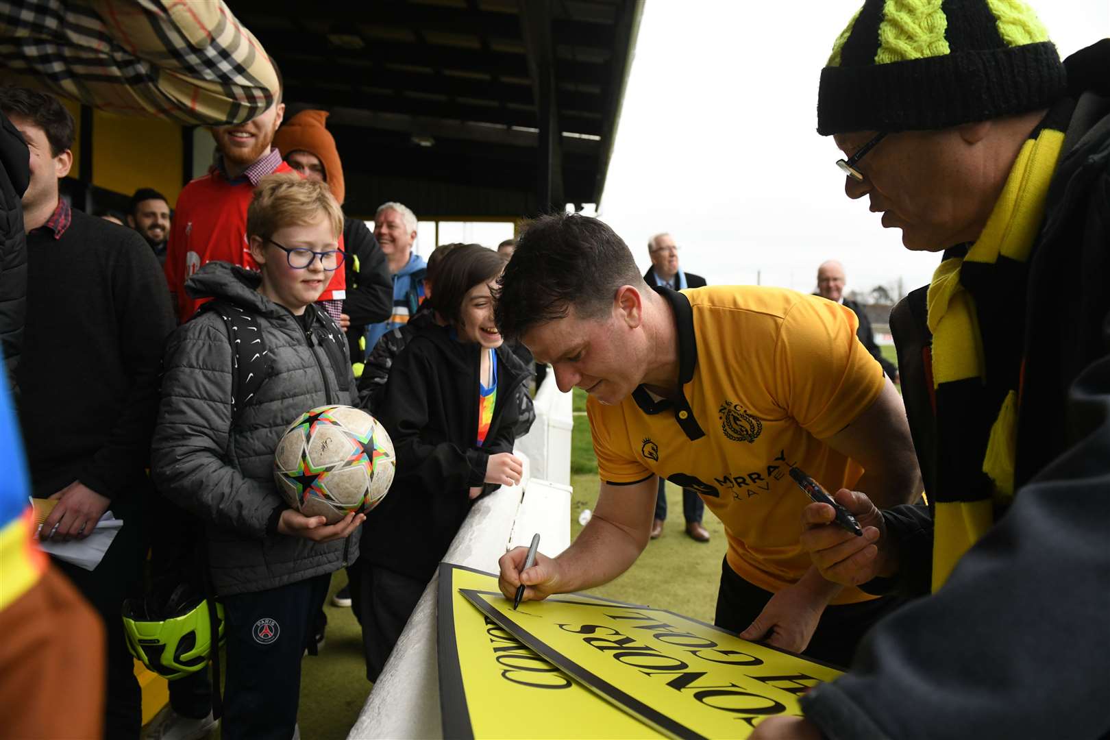 Conor Gethins signs autographs for Nairn fans celebrating his 200 goals. Picture: James Mackenzie