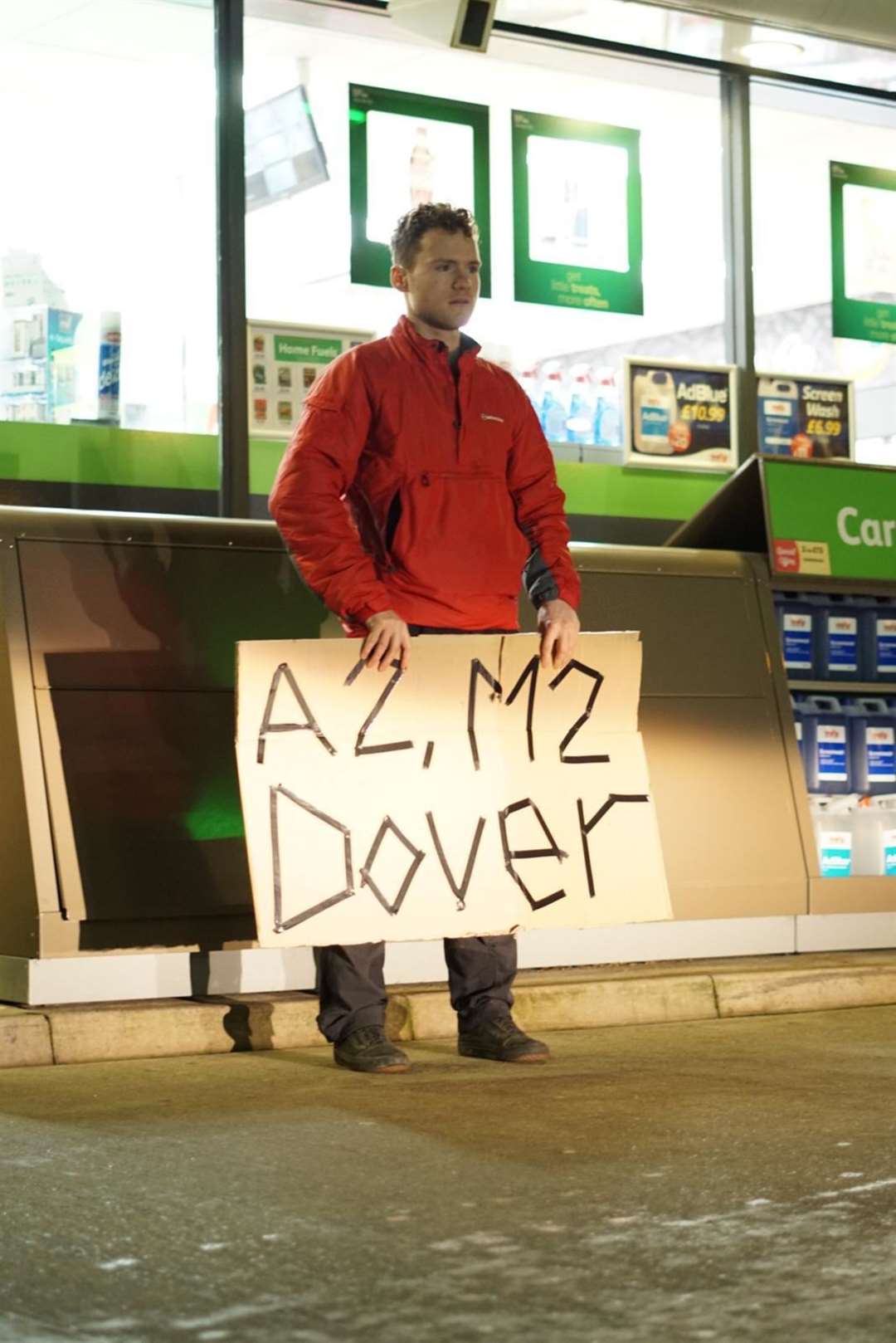 Owen Hope with a sign asking for a lift to Dover.