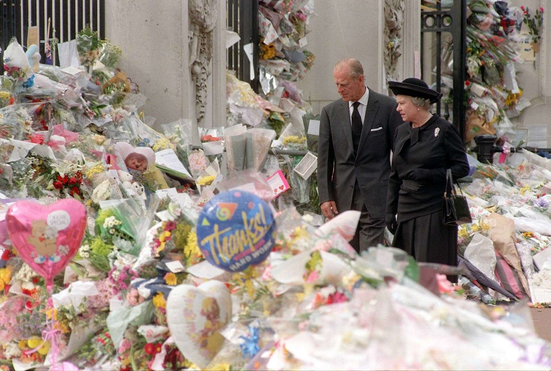 The Queen and Duke of Edinburgh view the floral tributes to Diana, Princess of Wales, after her death in a car crash in Paris in 1997 (John Stillwell/PA)