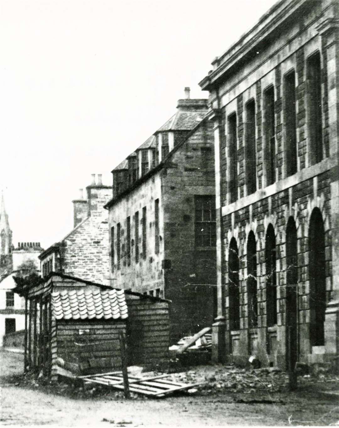 The former bank building on the extreme right during the period of construction showing rubble on the ground and workmen's sheds. Shared by Thurso historian Alan McIvor.