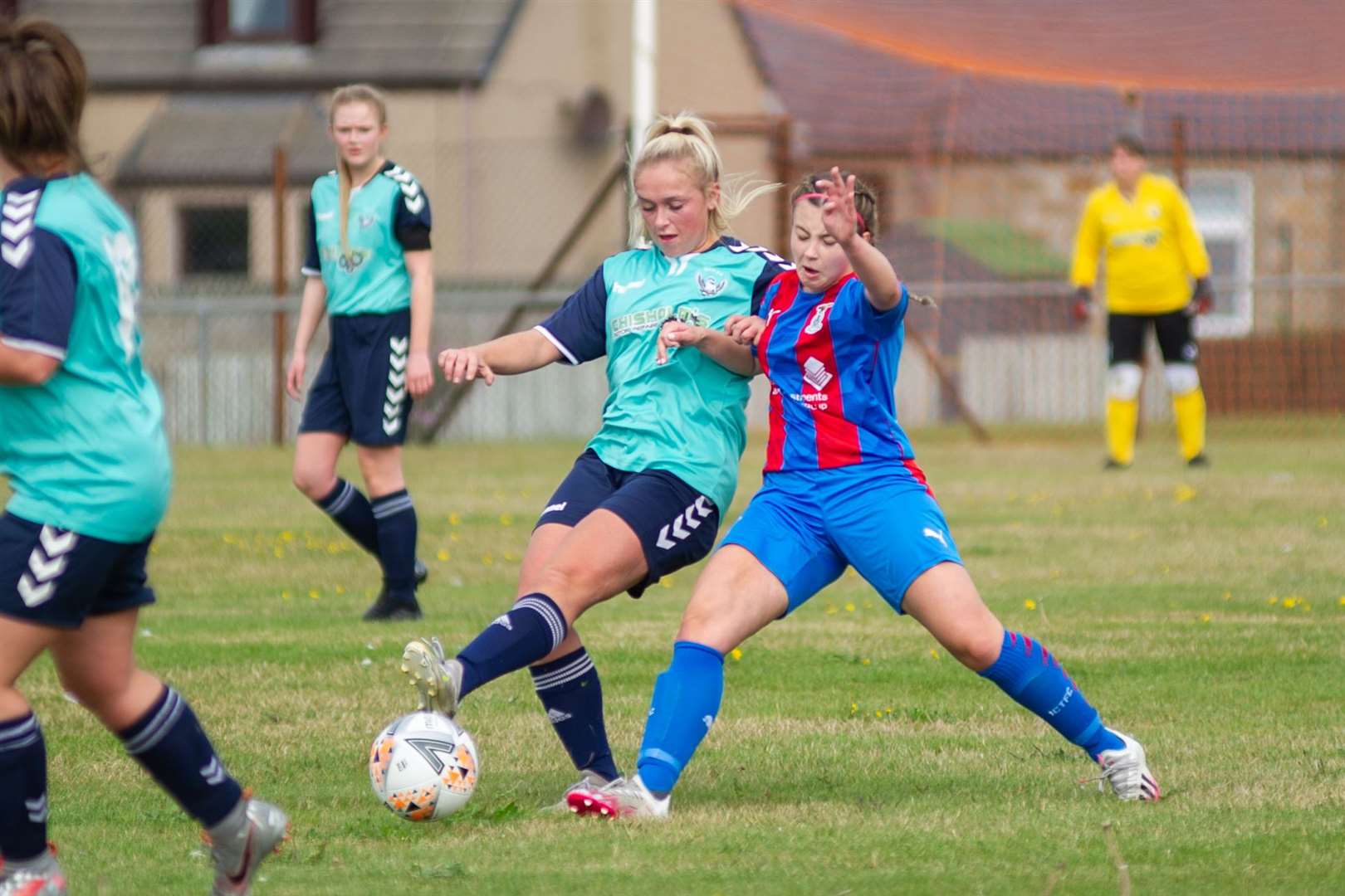 Chloe McAllister tries to barge Buckie Ladies Emily McAuslan off the ball. Picture Daniel Forsyth.