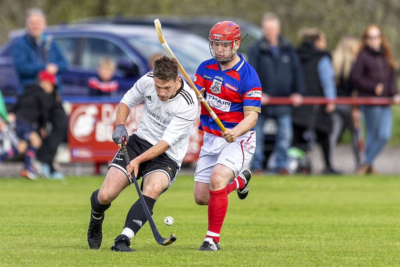 Lovat's Daniel Grieve gets to the ball before Savio Genini (Kingussie). Kingussie v Lovat in the cottages.com MacTavish Cup semi final played at The Dell, Kingussie.