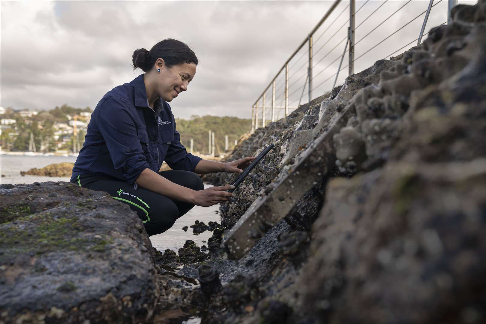 Dr Maria Vozzo conducts a biodiversity count on a Living Seawall fitted to sea defences in Sydney, Australia (Conor Ashleigh/Earthshot Prize/PA)